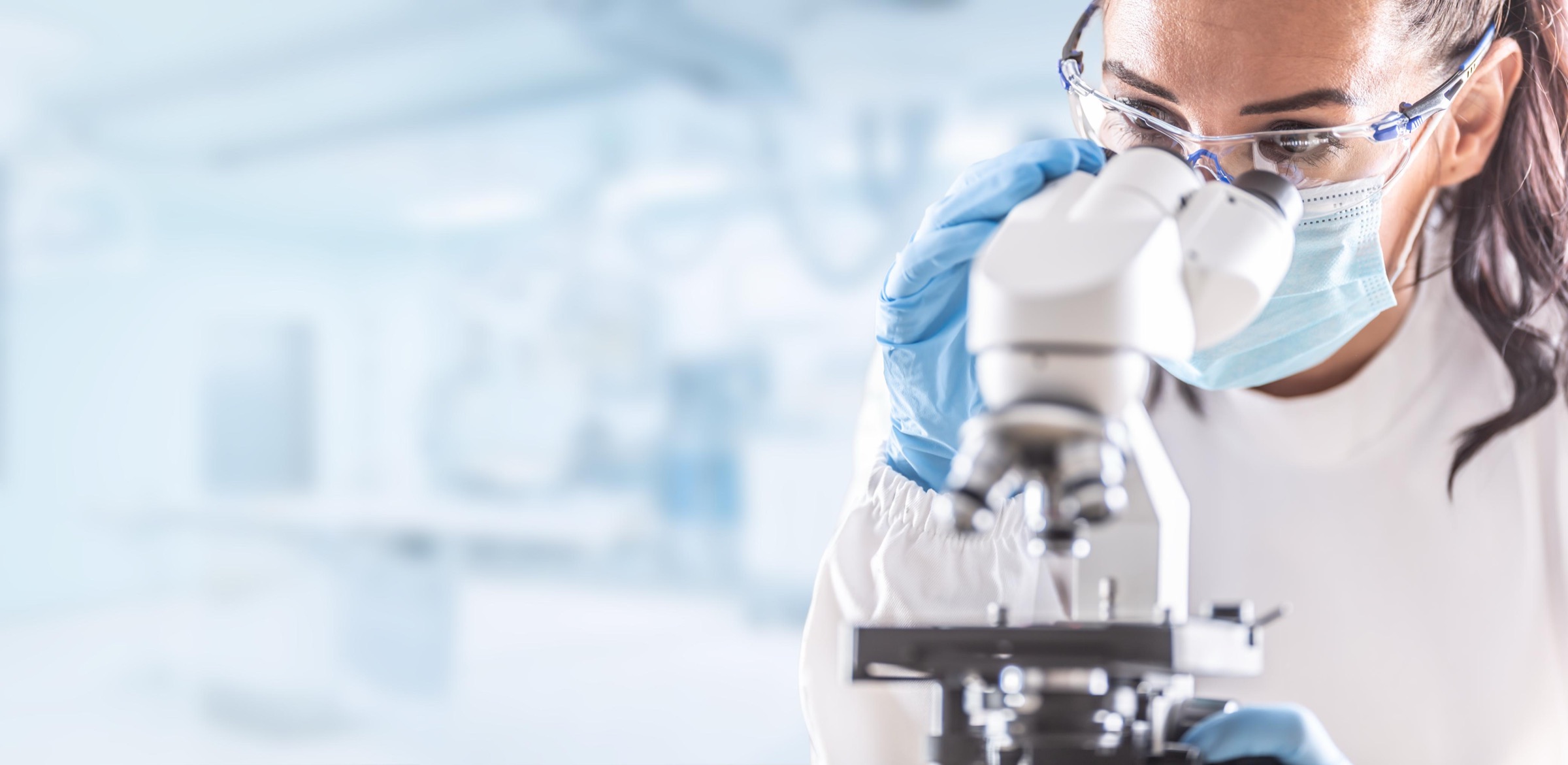 A researcher looking into a microscope in a calcium research laboratory